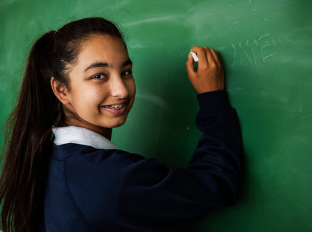 Young Student in Uniform with Chalk Board
