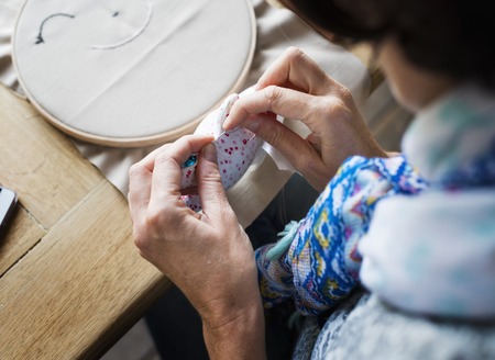 Closeup of hands sewing doll handicraft handmade