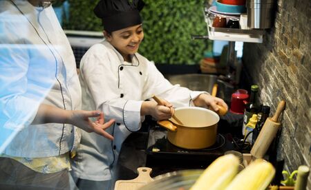 Little girl learning cooking with her family