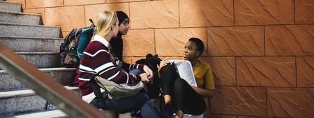 Group of students talking at the stairs