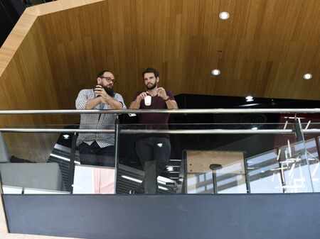 Men colleagues coffee break talking together