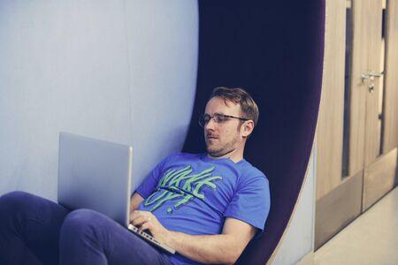 Man working on laptop networking technology