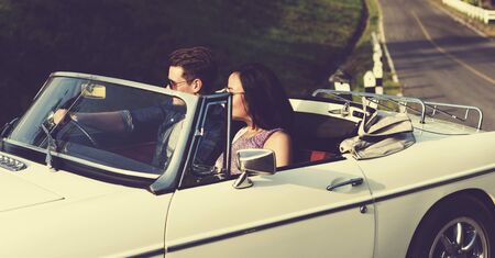 Couple Driving a Car Traveling on Road Trip Together