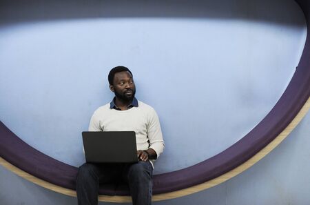 Man working on laptop networking technology
