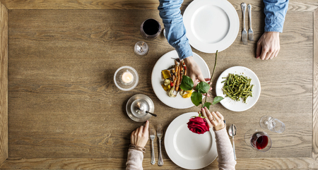 Man giving a rose for the lady at dinner