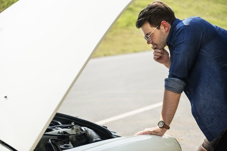Men Checking Broke Down Car on Street Side with Open Hood