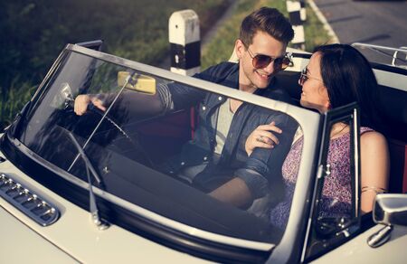 Couple Driving a Car Traveling on Road Trip Together