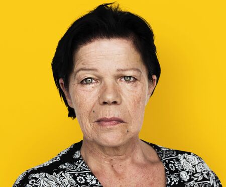 Senior adult woman in moody studio portrait