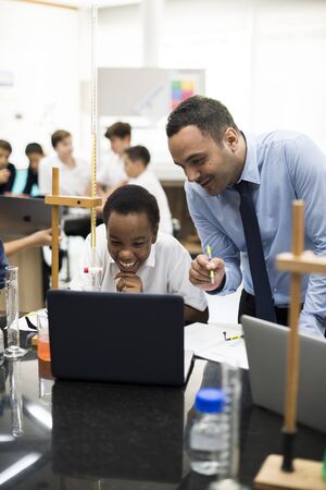 High school students studying in chemistry laboratory experiment class