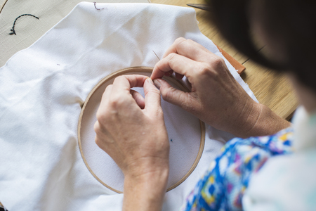 Closeup of hands with embroidery handicraft handmade