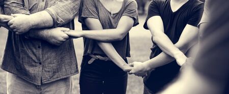 Group of diverse people holding hands support team unity