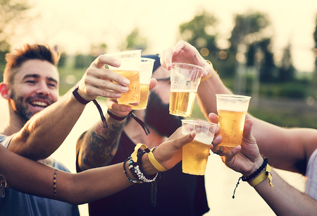 Group of Friends Drinking Beers Enjoying Music Festival Together
