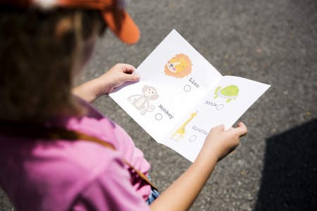 Kid hands holding animal book