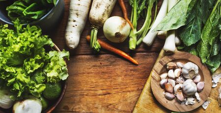 Cloves of garlic and diverse vegetable on the table