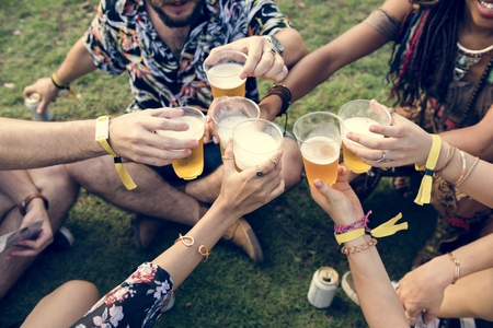 Group of Friends Drinking Beers Enjoying Music Festival Together