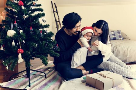 Father and mother are taking care of their child.