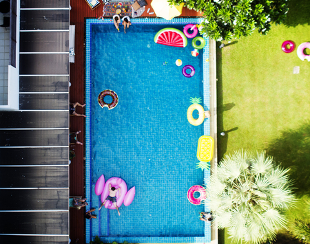 Aerial view of people enjoying the pool with inflatable tubes