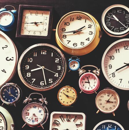 Closeup of various clocks isolated on black