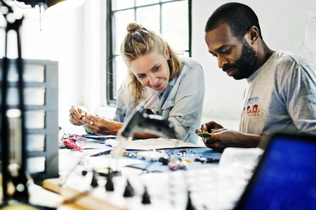 Technicians working on electronics parts