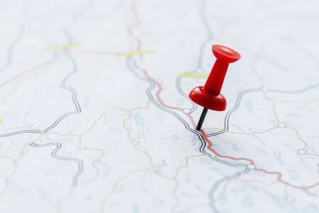 Closeup of pushpin showing the location on the map