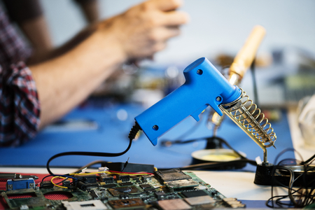 Side view of soldering tool on technician workshop