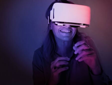 Woman using virtual reality gadget for entertainment