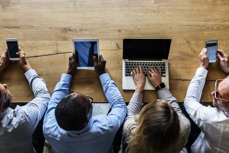 Business people in a meeting using devices