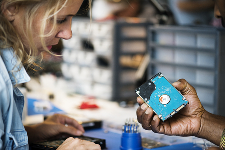 Technicians working on computer hard disk