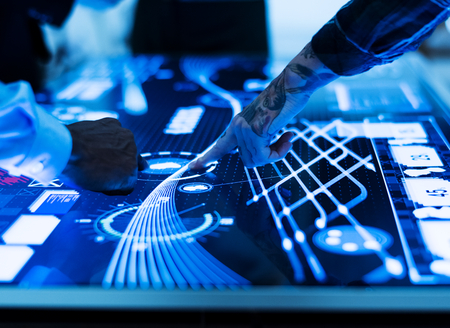 Hands with tattoo touching cyber space table brainstorming