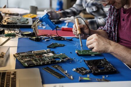 Closeup of tin soldering with electronics circuit board