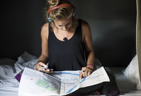 Caucasian woman checking using Bangkok Thailand map
