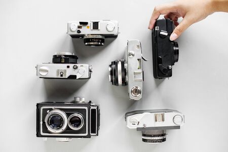Hand holding camera isolated on background