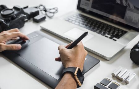 Designer holding stylus on digital tablet