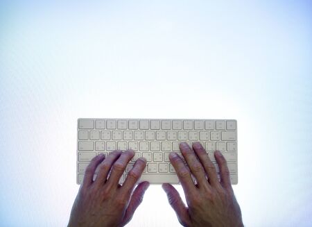 Hands typing on a keyboard
