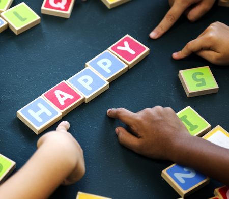 Kids spelling out words with alphabet blocks