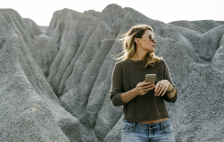 Woman hiking to the top of mountain in nature
