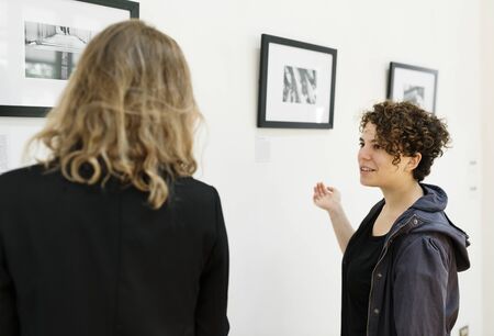 People looking at frames in exhibition