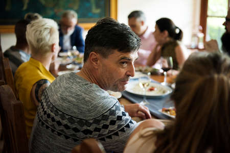 Group of diverse friends are having a dinner together