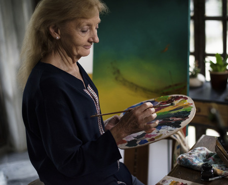 Artist working on acrylic artwork