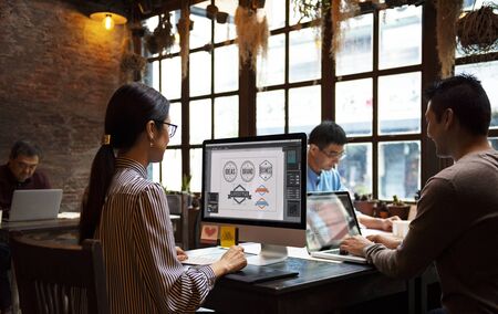 Group of designers working together in a cafe