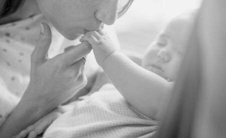 Mother kissing her baby