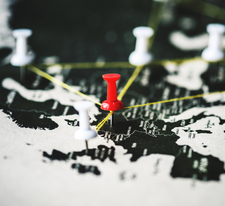 Closeup of pins on world map journey travel
