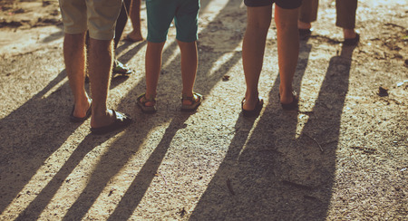 Rear view of caucasian family walking to the beach together