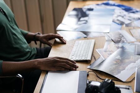 Close up of people's hand working on computer