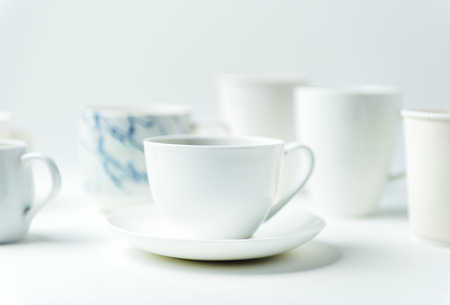 Closeup of coffee cups on white table
