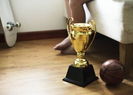 Closeup of trophy on the bedroom floor with basketball