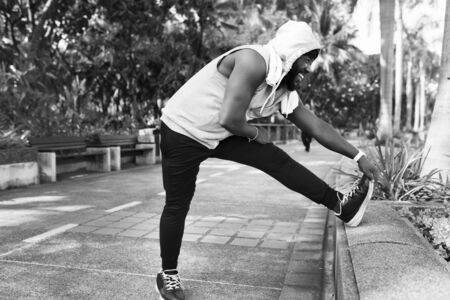 African descent man stretching at the park