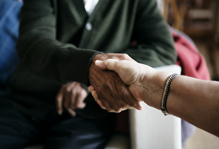 Foto de Senior people casual greeting shaking hands - Imagen libre de derechos