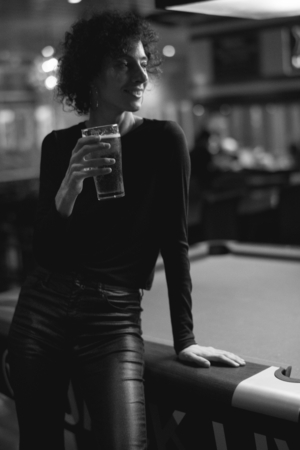 Woman having a beer at a bar