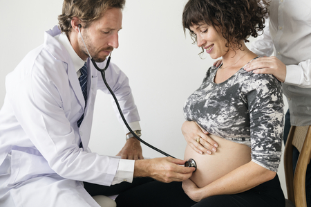Pregnant woman having fetal monitoring by doctor